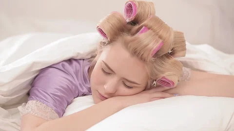 Charming blonde sleeps in bed while staying at home during the coronavirus Stock Footage 130156232