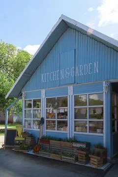 Charming blue rustic store with gardening and kitchen decor elements Stock Photos