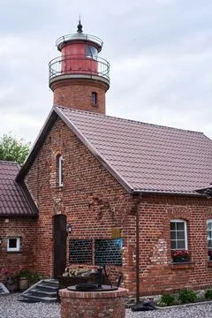 Charming Brick Lighthouse Featuring a Cozy Home Nestled Along the Scenic Coastal Stock Photos