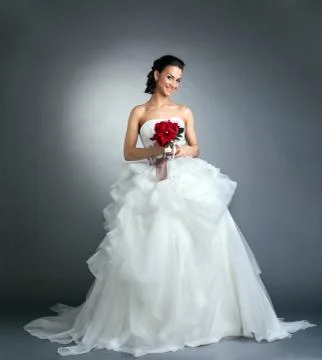 Charming bride with bouquet posing in studio Stock Photos