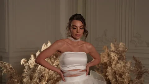 Charming bride keeps her hands on her waist Stock Footage 239232797