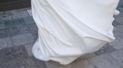 Charming brunette bride dancing with her dress and white veil, while happy groom Stock Footage 66003172