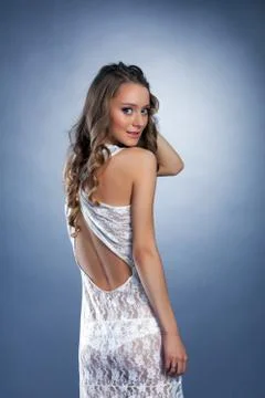 Charming brunette shows white erotic lacy dress Stock Photos