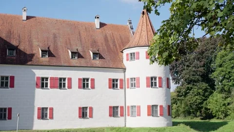 A Charming Castle Featuring Beautiful Red Shutters, Elegantly Surrounded by Lush Stock Footage 318896957
