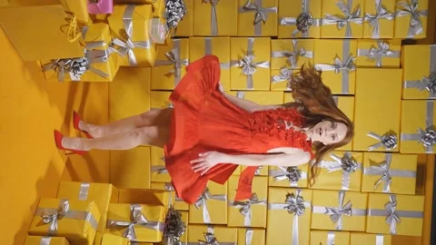 A charming Caucasian lady in an elegant red evening dress is inspired by her Stock Footage 162542831