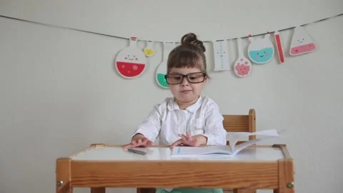 Charming child plays pretending to be a teacher. Stock Footage 199304563