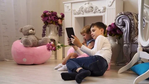 Charming children play with the tablet Stock Footage 76272764