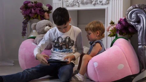 Charming children play with the tablet 스톡 동영상 76272977