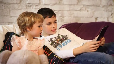 Charming children play with the tablet Stock Footage 76273968