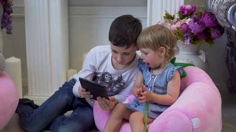 Charming children play with the tablet Stock Footage 76279852