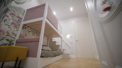 Charming children's room featuring a bunk bed with pink upholstery Stock Footage 271199777