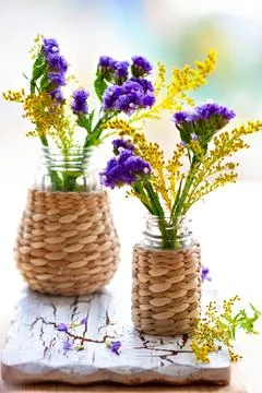 Charming composition of two glass jars wrapped in woven texture, filled wit.. Foto stock