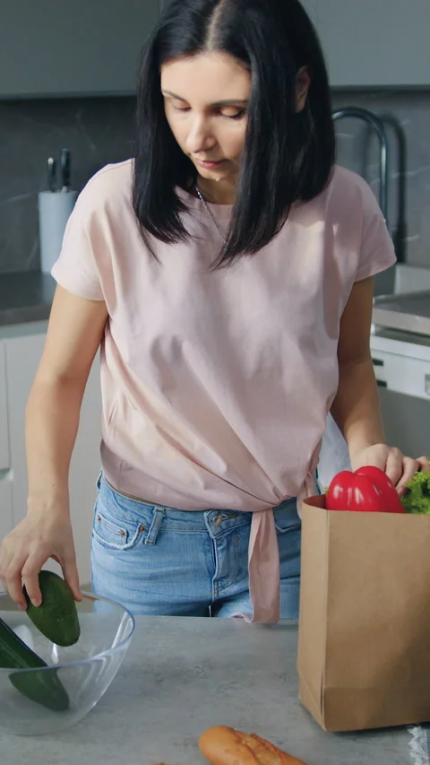 Charming concentrated 30-aged dark-haired woman came back from supermarket with  Stock Footage 330064013