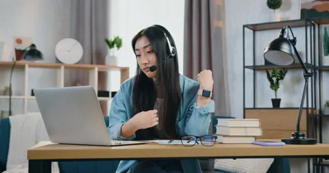 Charming confident enterprising skilled 25-aged asian girl in headset holding Stock Footage 150968844