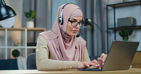 Charming confident successful 30-aged muslim woman in headscarf and eyeglasses Stock Footage 150163555