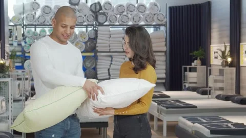 Charming couple selecting cozy pillows at a stylish furnishings store Stock-Footage 311937735