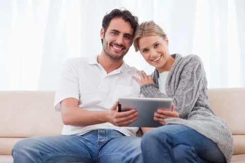Charming couple using a tablet computer Stockfoto's