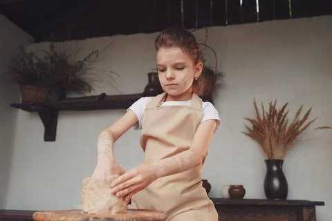 Charming craftsman little girl enjoying pottery art and producti Stock Photos