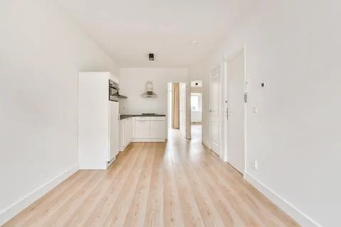 Charming design of a large room with a kitchen area and parquet floor Stock Photos