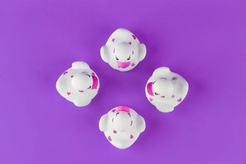 A Charming Display of Four Unique Rubber Ducks with Pink Hearts on a Vibrant Stock Photos