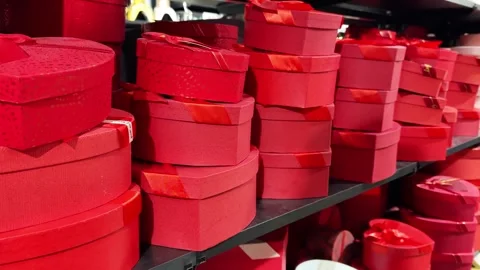 Charming display of stacked red gift boxes on elegant black shelves Stock Footage 292025141