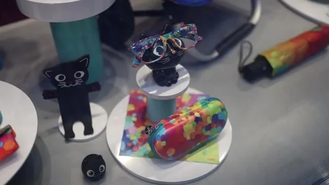 A charming display in a toy store featuring black cat-themed accessories, includ Video stock 300115127