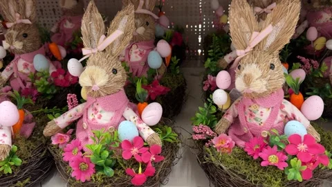 Charming Easter Bunny Figurines In Floral Nests With Colorful Eggs Stock Footage 327796069