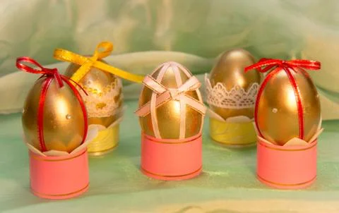 Charming Easter eggs on the legs with bows Stock Photos