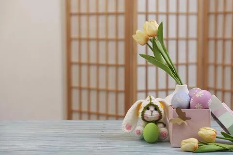 A charming Easter scene featuring a bunny, tulips, and decorated eggs, perfect Stock Photos