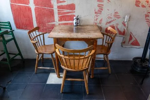 Charming empty cafe interior with vintage wooden chairs and table in Guadalajara Stock Photos