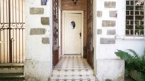 Charming Entry with Wrought Iron Gates, Stone Accents, and Patterned Tile Floor Stock Footage 307170058