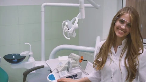 Charming female doctor posing for camera, confidence and professionalism, clinic Stock Footage 128258223