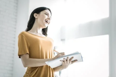 Charming female student taking notes Stock Photos