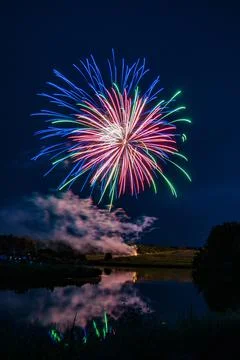 Charming firework explosion in the evening sky Stock Photos