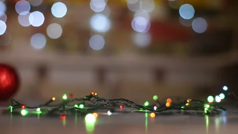 Charming fluffy cat walking around xmas colorful twinging garland on blurred Stock Footage 255125474