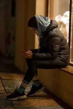 Charming focused woman using a mobile phone outdoors Stock Photos