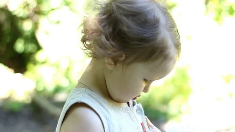 Charming funny happy child is drinking water from a bottle in the summer. Stock Footage 78260758
