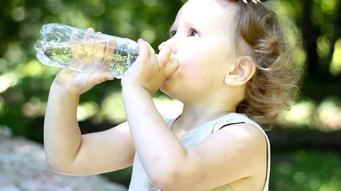 Teen boy drinking water outdoors Stock Video Footage by ©VaLiza #199836560