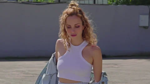 Charming ginger woman is thinking in empty parking lot near supermarket Stock-Footage 160555057