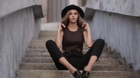 Charming girl in a black hat posing Stock Footage 67284011