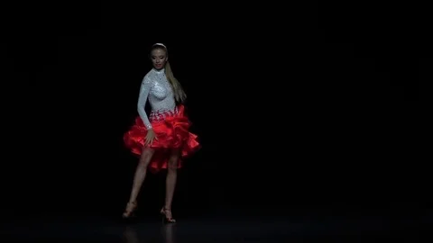 Charming girl dancing elements salsa, dark background. Slow motion Stock Footage 69796944