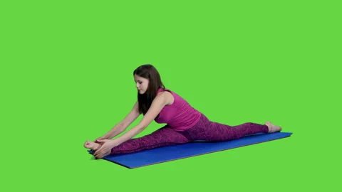 Charming girl doing stretching exercise sitting on fitness mat in splits pose Video stock 244859420