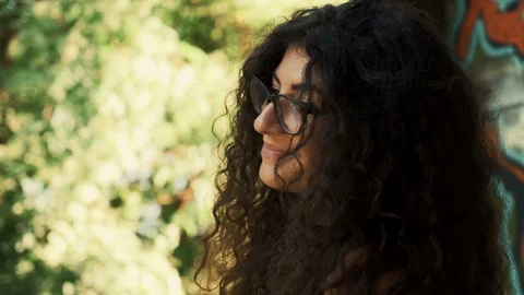 Charming girl with glasses smiling while posing for photo shoot Stock Footage 115707552