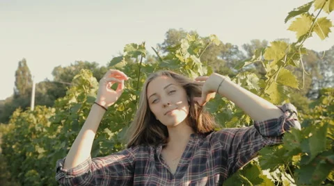 Charming girl with long hair posing next to a vineyard Stock Footage 59382372