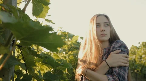 Charming girl with long hair posing next to a vineyard Stock Footage 59382674