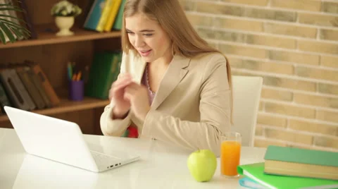 Charming girl sitting at table using laptop holding credit card looking  Stock Footage 34114660