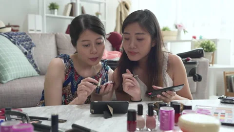 Charming girls discussing tips doing makeup Stock Footage 133470520