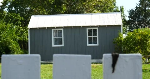 Charming Gray House Behind White Picket Fence Stock Footage 262400889