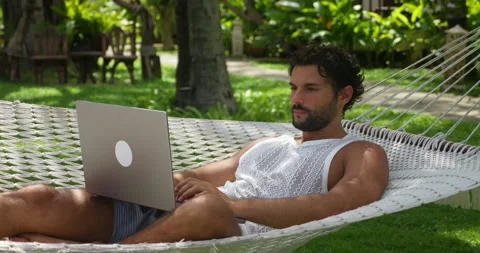 Charming guy, developer programmer, copywriter turning on a laptop PC while Stock Footage 221703540