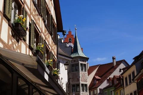 Charming half-timbered house with white and yellow flowers on windows and other Stock Photos